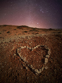 Scenic view of desert against sky at night