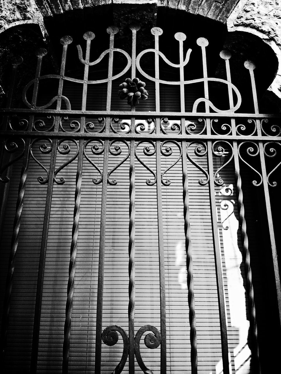 architecture, built structure, building exterior, wall - building feature, text, pattern, low angle view, graffiti, window, wall, western script, railing, bicycle, building, metal, gate, no people, brick wall, indoors, day