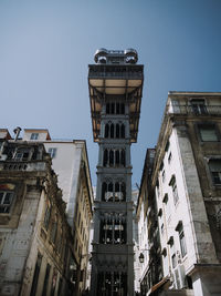 Low angle view of buildings against clear blue sky