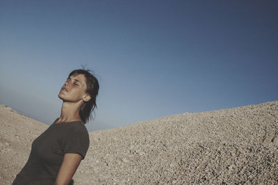 Full length of woman standing against clear sky