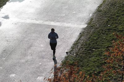 High angle view of man walking on road