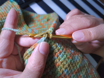 Cropped hands knitting crochet at home