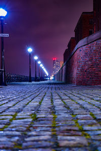 Surface level of footpath in illuminated city at night