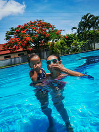 Portrait of mother and little daughter in swimming pool