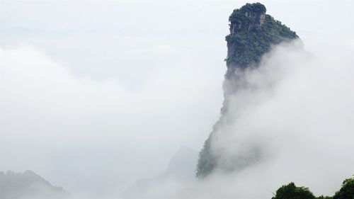 Scenic view of mountains against cloudy sky