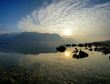 Scenic view of lake against sky during sunset