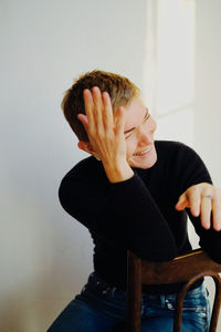 Woman looking away while sitting on seat