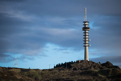 Low angle view of communications tower against sky