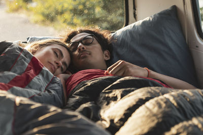 Girlfriend and boyfriend resting in van during vacation
