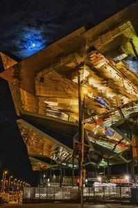 Low angle view of illuminated building against sky at night