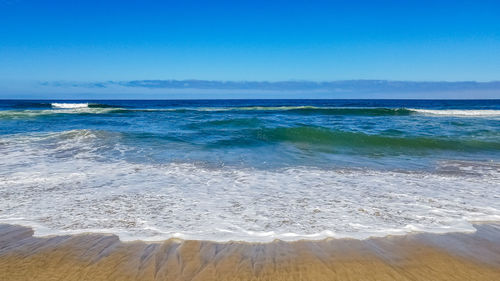 Scenic view of sea against blue sky