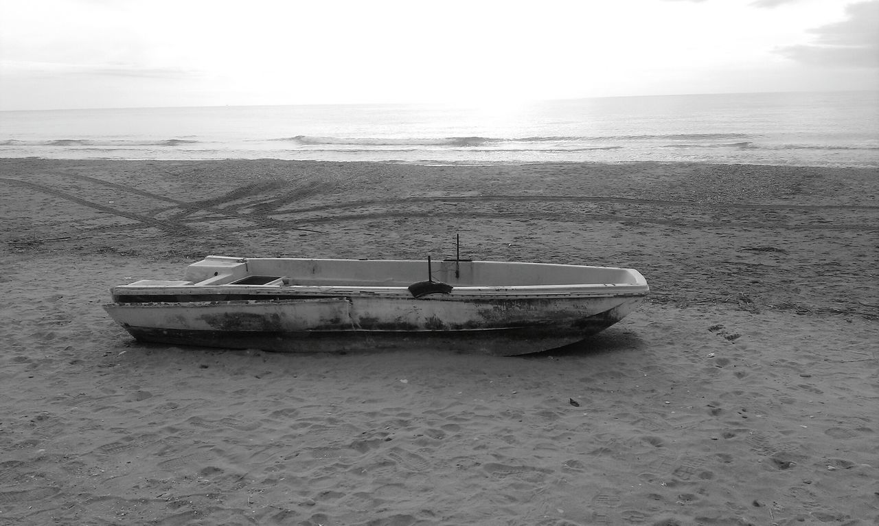 sea, horizon over water, beach, water, nautical vessel, boat, transportation, mode of transport, shore, sand, sky, moored, tranquility, tranquil scene, scenics, nature, beauty in nature, idyllic, travel, abandoned