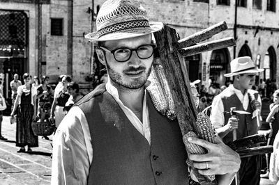 Portrait of young man standing in city