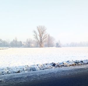 Scenic view of frozen lake against clear sky during winter