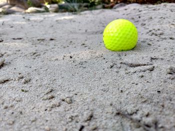 Close-up of yellow ball on sand