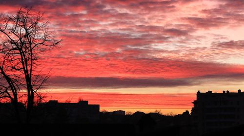 Silhouette of building against dramatic sky