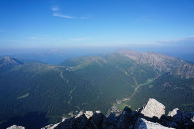 Scenic view of mountains against blue sky