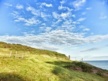 Scenic view of landscape against cloudy sky