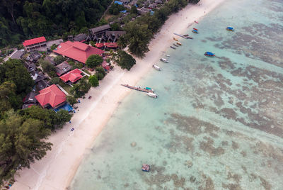 High angle view of houses at beach against trees