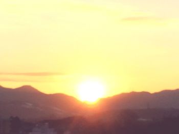 Scenic view of silhouette mountains against sky during sunset