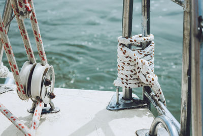 Close-up of tied up of metal chain on sea