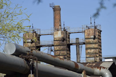 Low angle view of smoke stack against sky