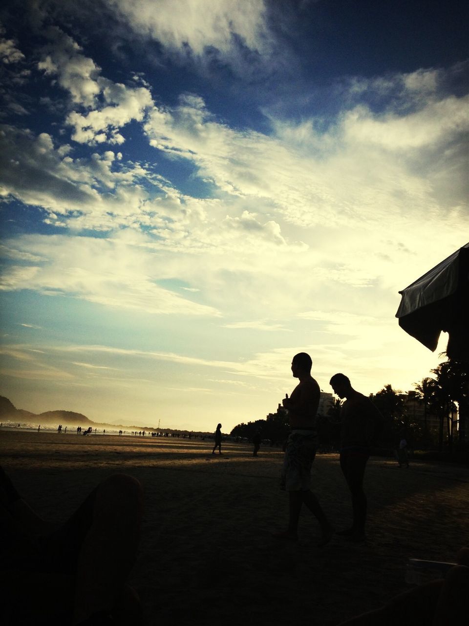 beach, sky, lifestyles, leisure activity, men, togetherness, silhouette, sand, shore, full length, sea, person, cloud - sky, vacations, standing, bonding, nature, sunset