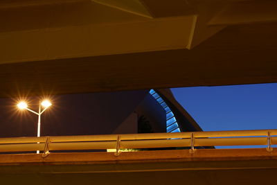 Low angle view of illuminated bridge against sky at night
