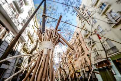 Low angle view of decorations hanging amidst buildings in city