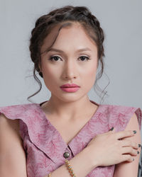 Close-up portrait of beautiful young woman over white background