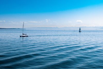 Lone boat in calm blue sea against sky