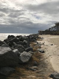 Rocks on beach against sky