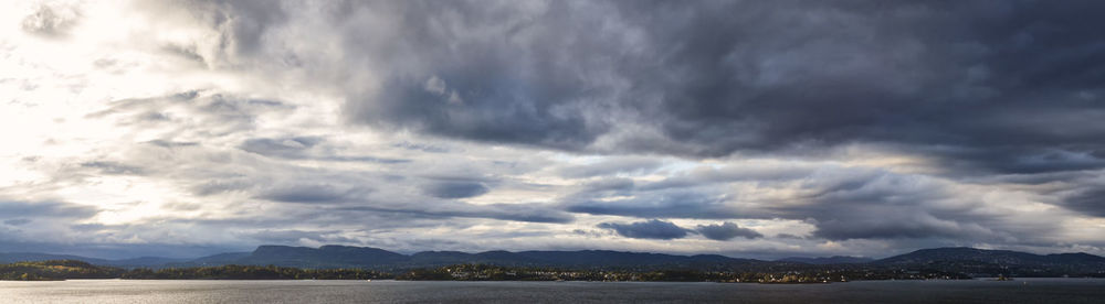 Scenic view of storm clouds over landscape