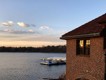 House by building against sky during sunset