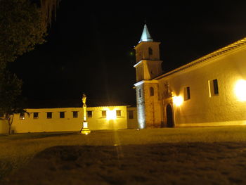 Illuminated church against sky at night