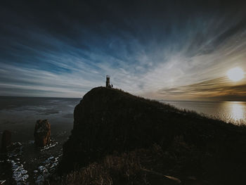 Old lighthouse in the rays of winter sunset