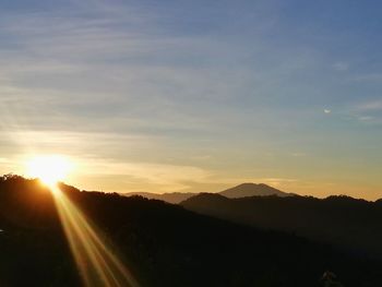 Scenic view of silhouette mountains against sky during sunset