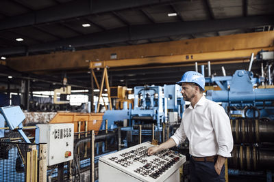 Side view of a man working in factory