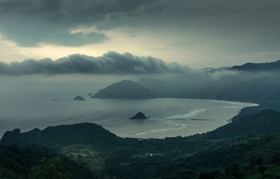 Scenic view of sea and mountains against sky