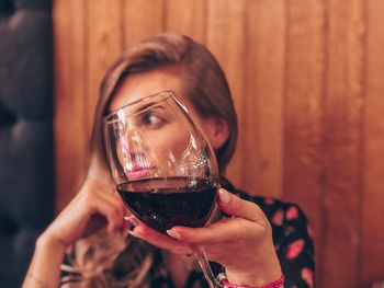 Midsection of a woman drinking glass