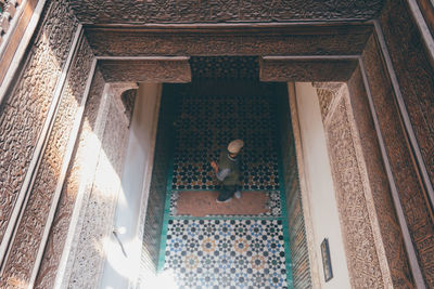 Low angle view of man walking on staircase of building