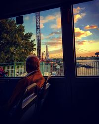 Rear view of man with cityscape in background