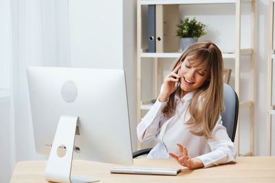 Young woman using laptop at office