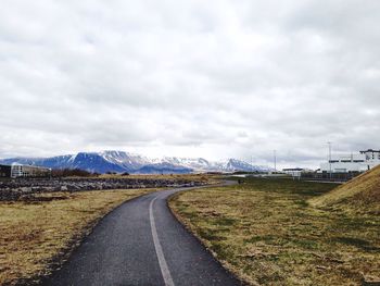 Country road leading towards mountains