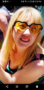 Portrait of smiling young woman wearing sunglasses