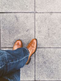 Low section of woman standing on tiled floor