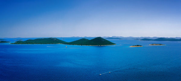 Scenic view of sea against clear blue sky