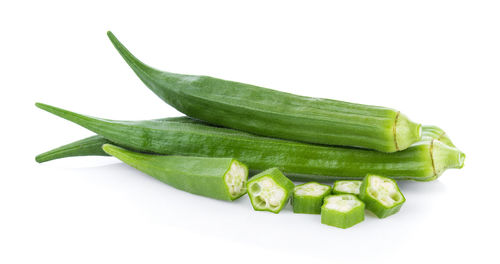 Close-up of lady fingers against white background