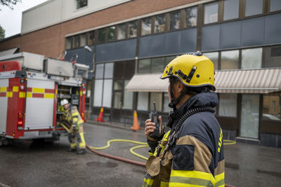 Firefighter talking via walkie talkie