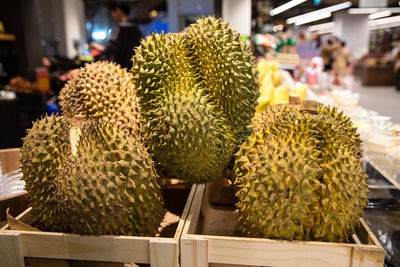 Fresh durians in wooden crate box for sales in a local market or supermarket